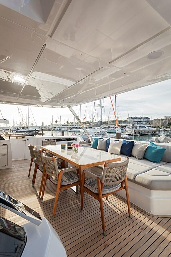 a table and chairs on a deck aboard ANINHA 1 Yacht for Sale
