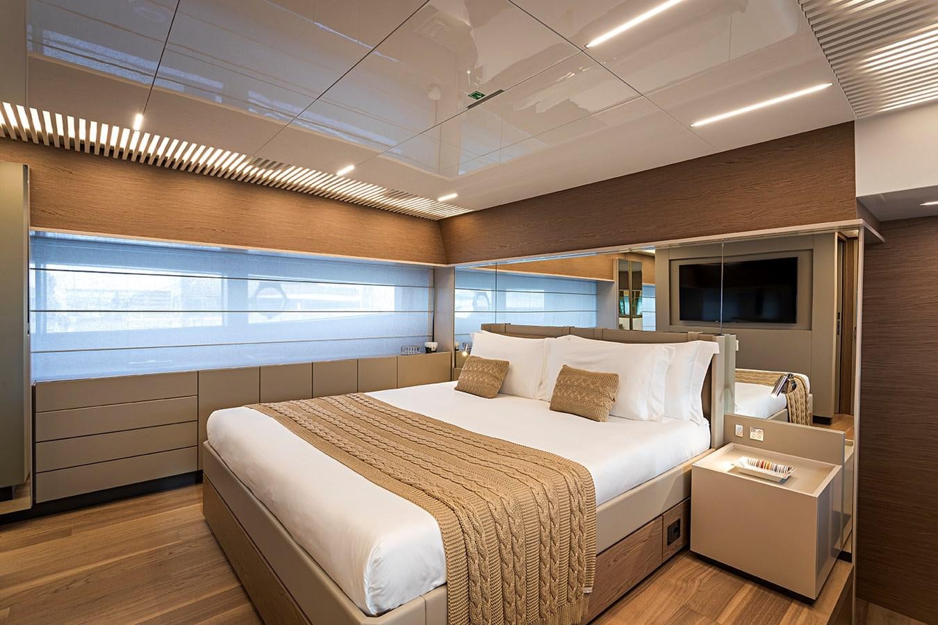 a bedroom with a bed and a window aboard ANINHA 1 Yacht for Sale