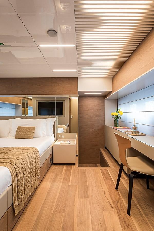 a bedroom with a wood floor aboard ANINHA 1 Yacht for Sale