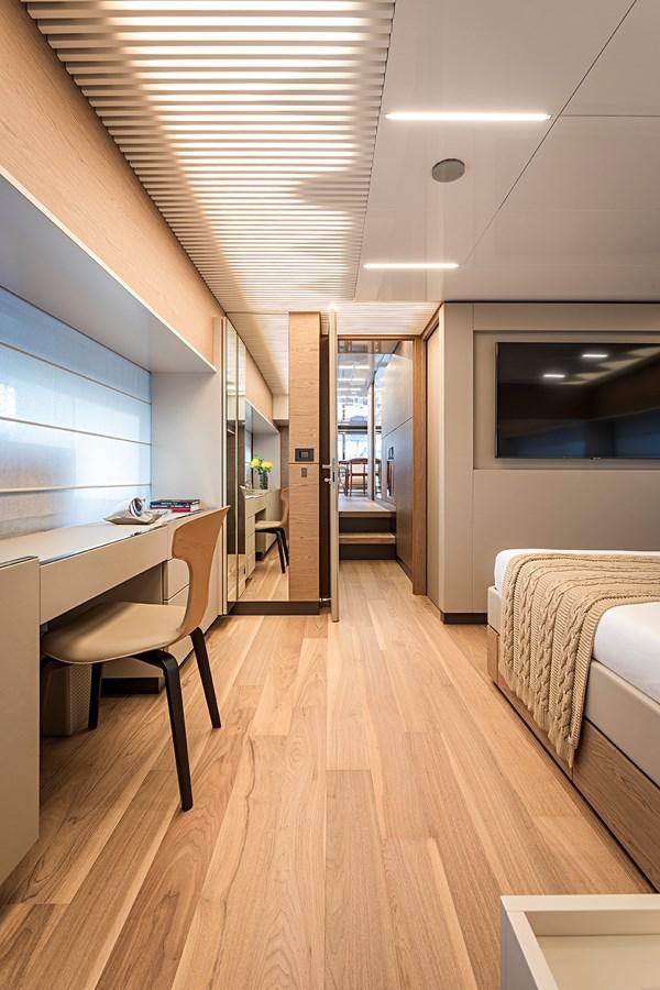 a bedroom with a wood floor aboard ANINHA 1 Yacht for Sale