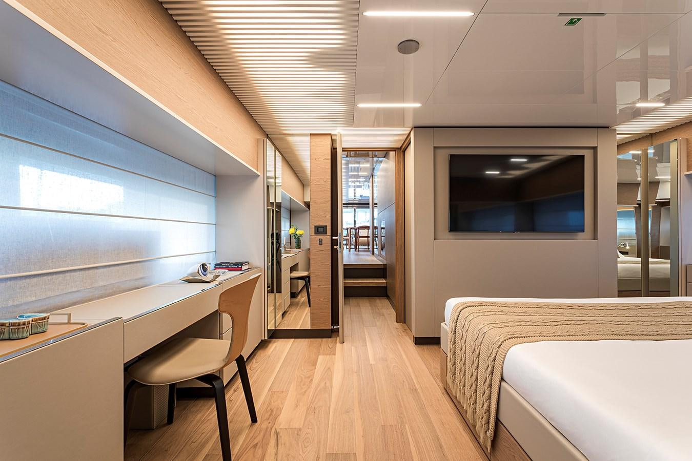a room with a bed and desk aboard ANINHA 1 Yacht for Sale