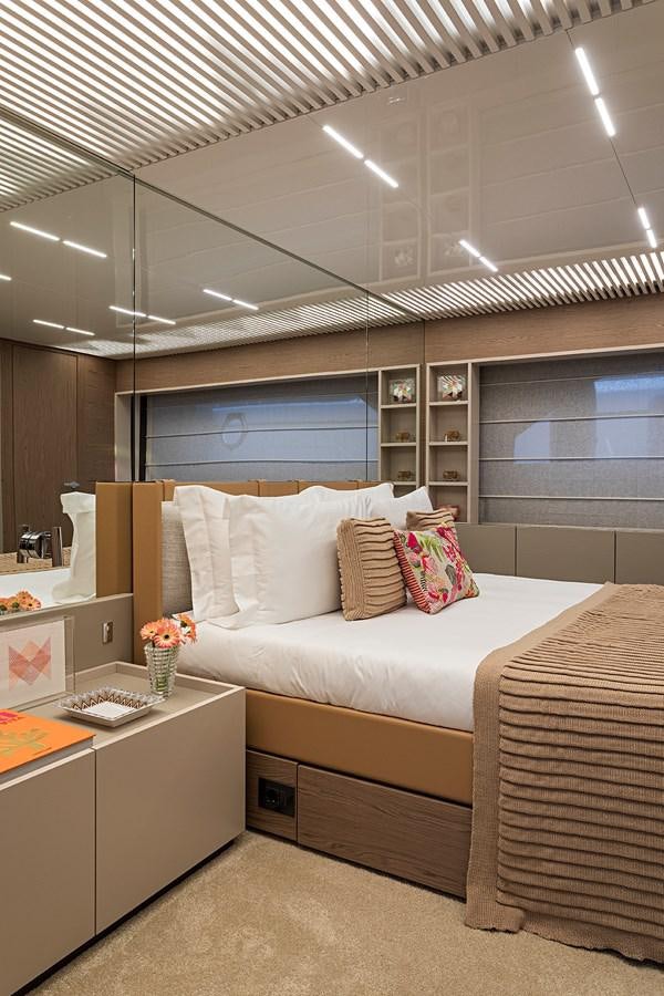 a bedroom with a bed and a desk aboard ANINHA 1 Yacht for Sale