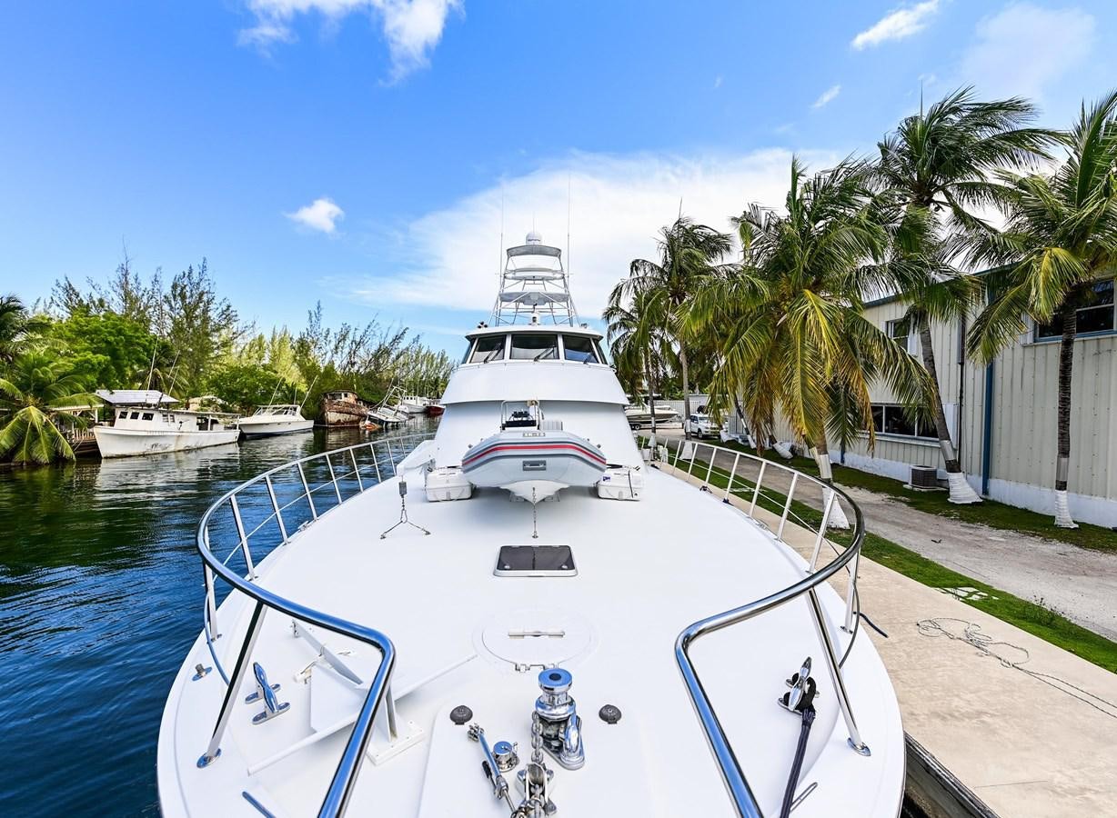 a white boat on a body of water aboard MAHA Yacht for Sale