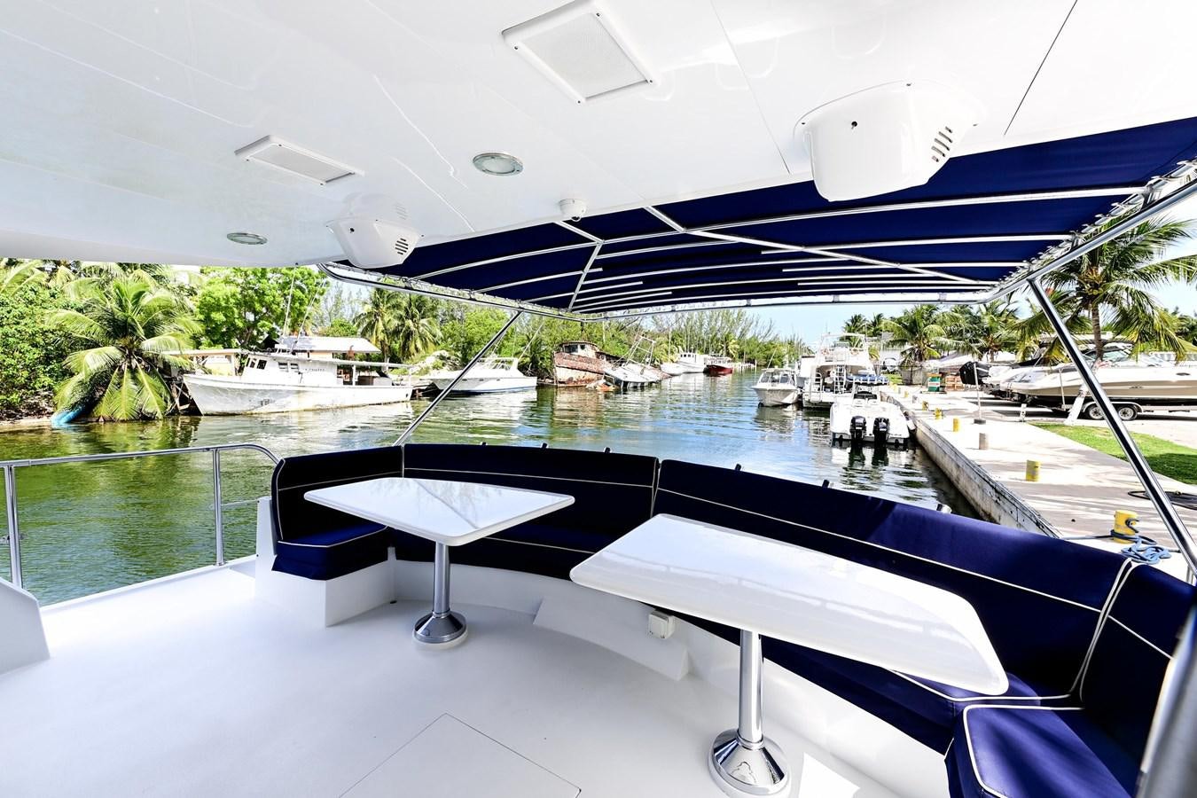 a pool with a table and chairs aboard MAHA Yacht for Sale