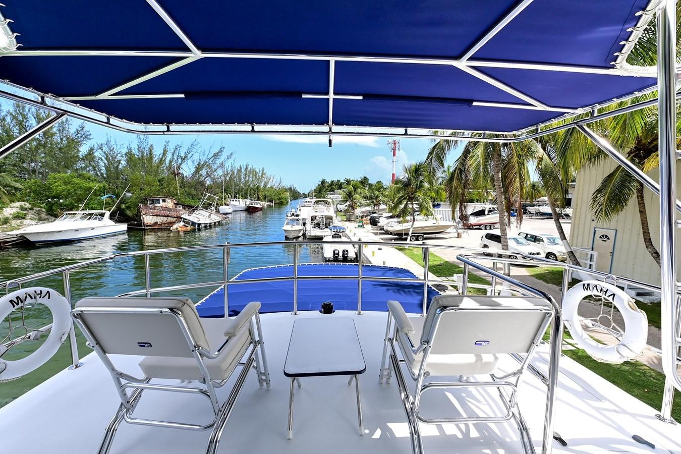a deck with a pool and chairs on it aboard MAHA Yacht for Sale