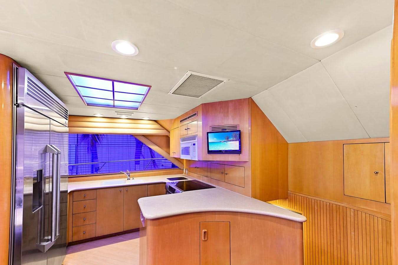 a room with a tv and a fridge aboard MAHA Yacht for Sale