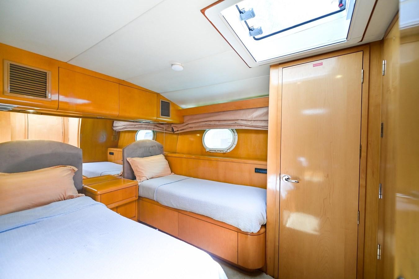 a cabin with a bed and a window aboard MAHA Yacht for Sale