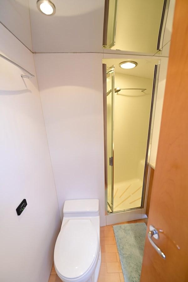 a bathroom with a toilet and a shower aboard MAHA Yacht for Sale
