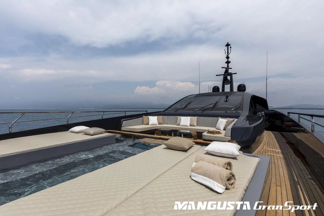 a pool with a building in the background aboard RR Yacht for Sale
