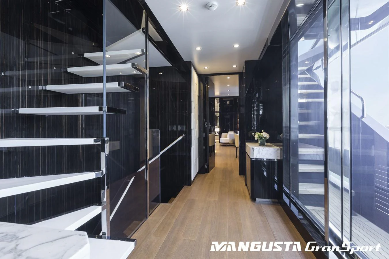 a room with a wood floor and a large glass wall with glass doors aboard RR Yacht for Sale