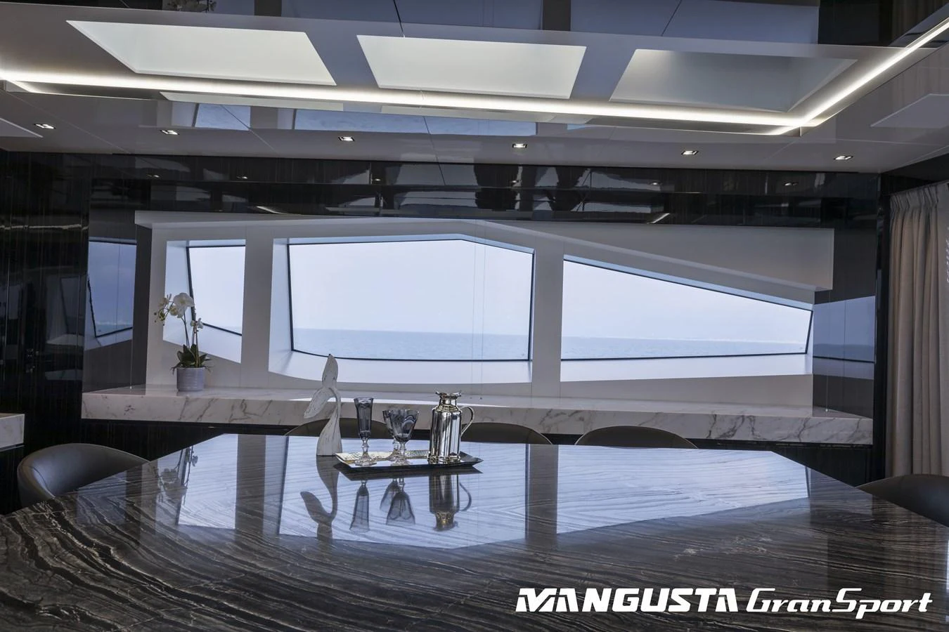 a room with a table and chairs aboard RR Yacht for Sale