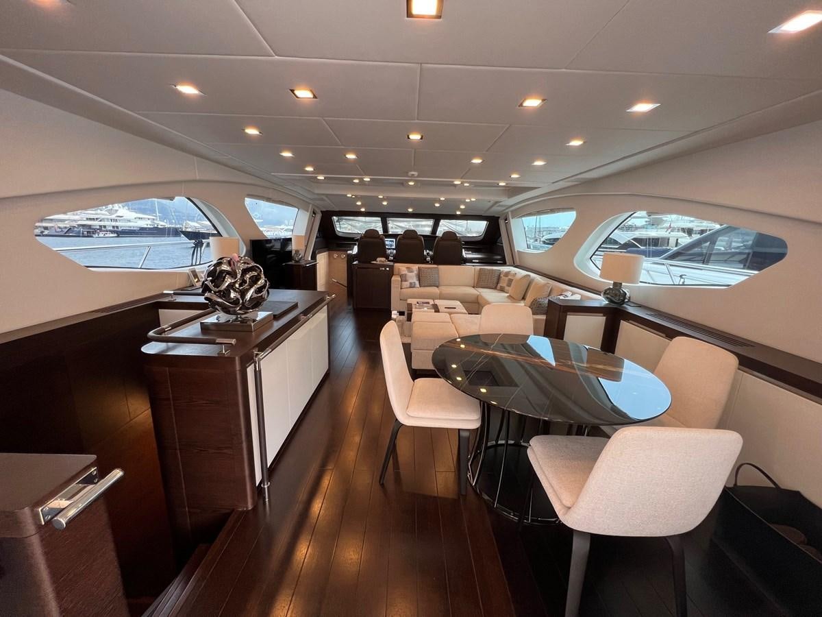 a room with a table and chairs aboard MANGUSTA MAXIOPEN 94#2 - MISS BUBBLES - CAREFULLY USED Yacht for Sale