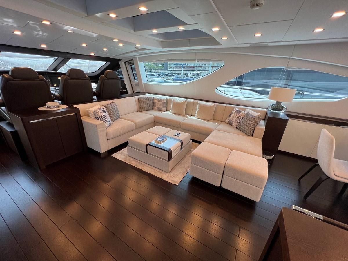 a living room with a large window aboard MANGUSTA MAXIOPEN 94#2 - MISS BUBBLES - CAREFULLY USED Yacht for Sale