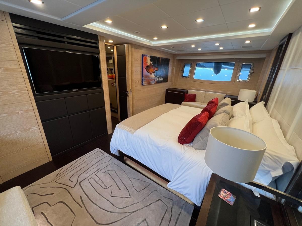 a hotel room with a bed and a television aboard MANGUSTA MAXIOPEN 94#2 - MISS BUBBLES - CAREFULLY USED Yacht for Sale