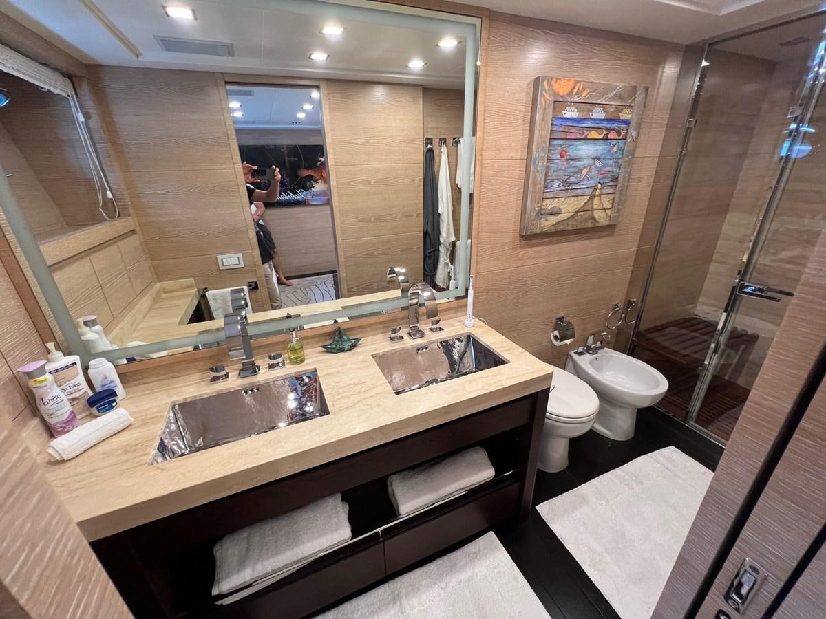 a bathroom with a sink and a mirror aboard MANGUSTA MAXIOPEN 94#2 - MISS BUBBLES - CAREFULLY USED Yacht for Sale