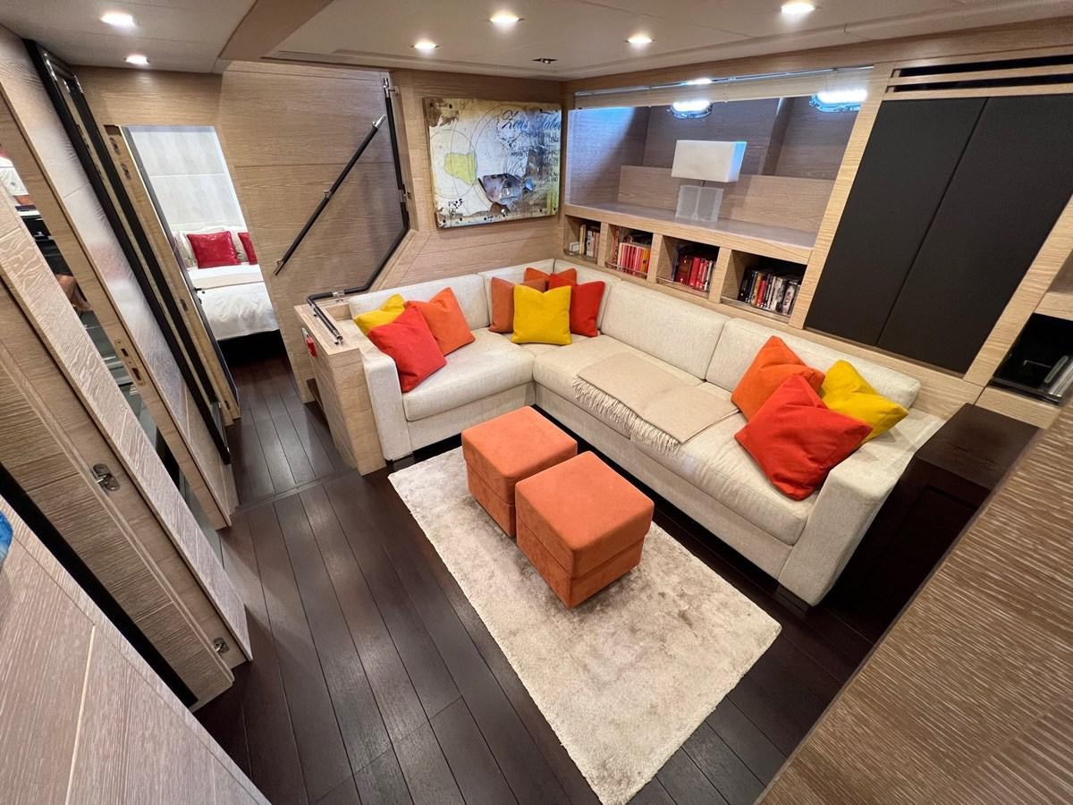 a living room with a couch and a table aboard MANGUSTA MAXIOPEN 94#2 - MISS BUBBLES - CAREFULLY USED Yacht for Sale