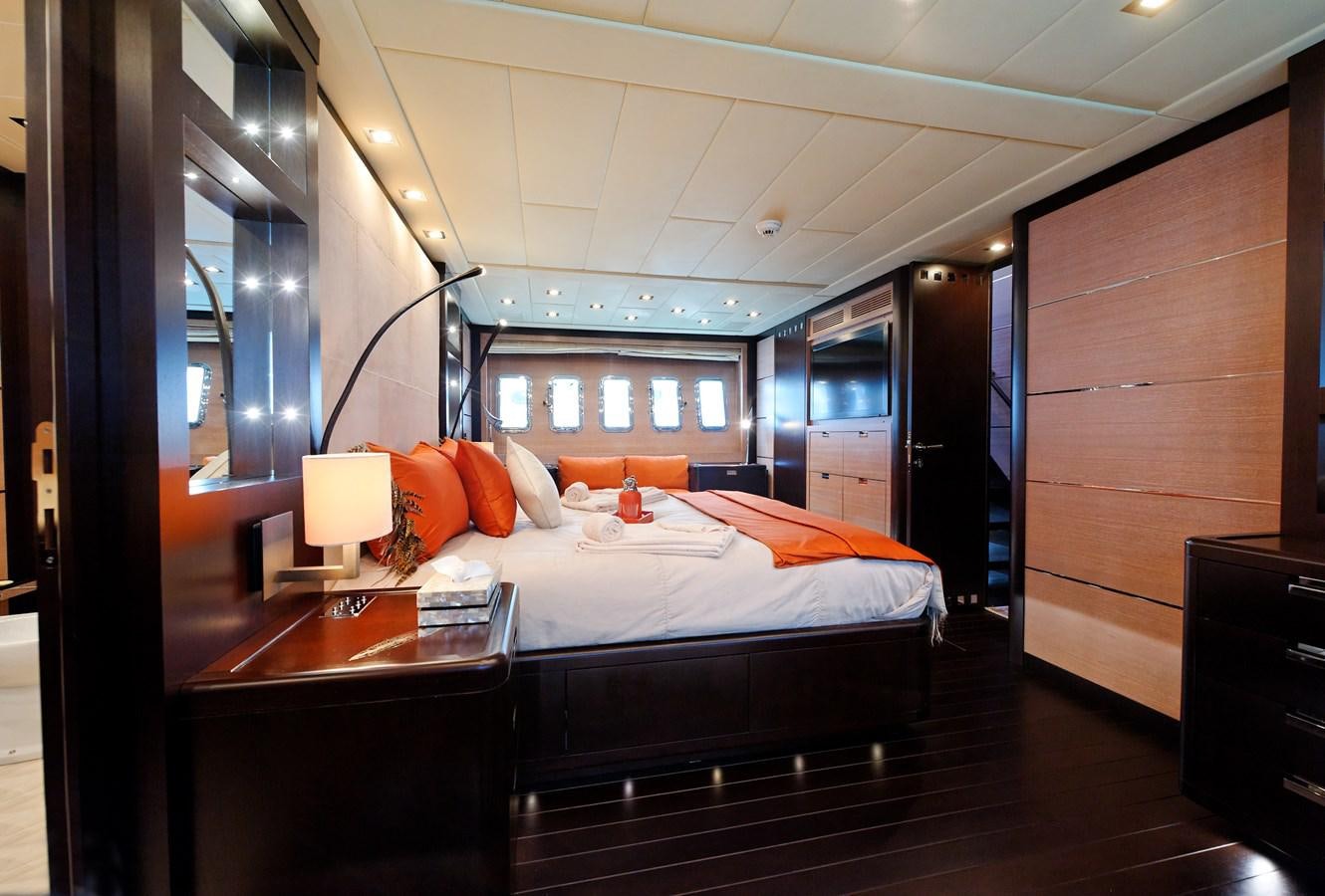a bedroom with a bed and a desk aboard CLAUDIA'S Yacht for Sale