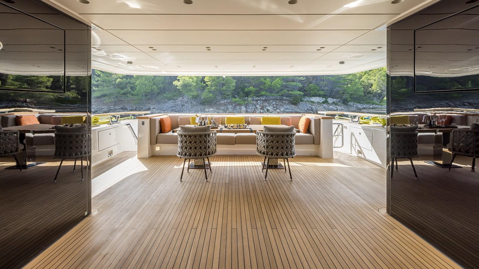 a room with tables and chairs aboard EROS Yacht for Sale