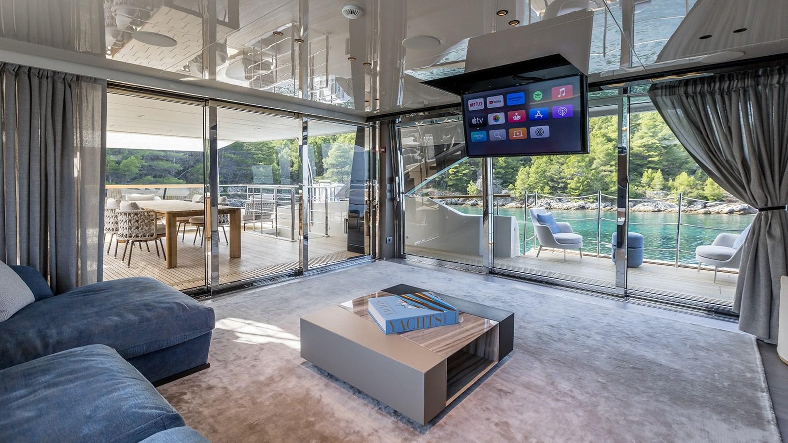 a living room with a large screen aboard EROS Yacht for Sale