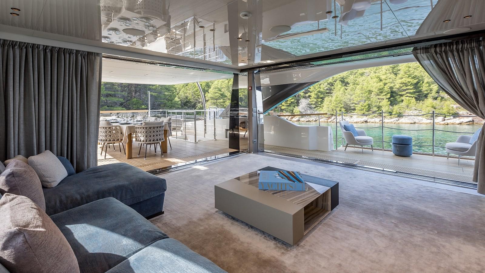 a large living room with a large patio area aboard EROS Yacht for Sale