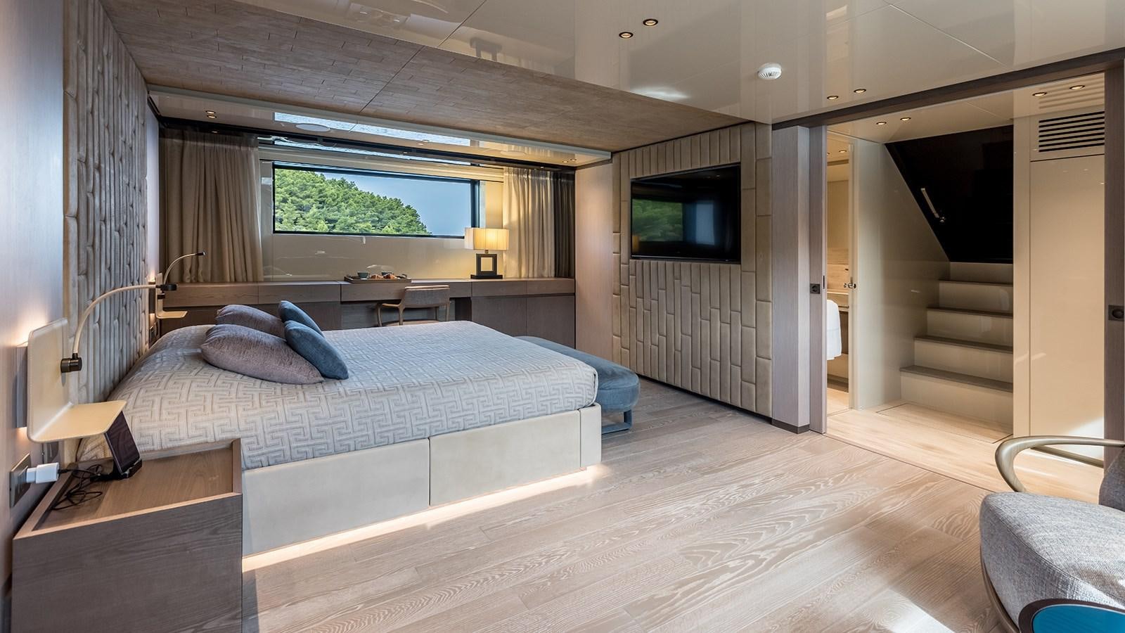 a large bedroom with a large bed aboard EROS Yacht for Sale