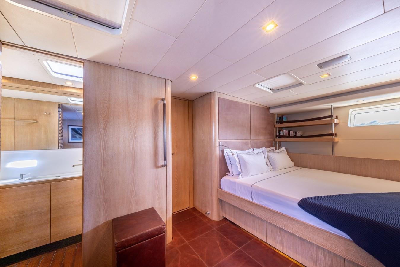 a room with a bed and a wood door aboard YCH2 Yacht for Sale