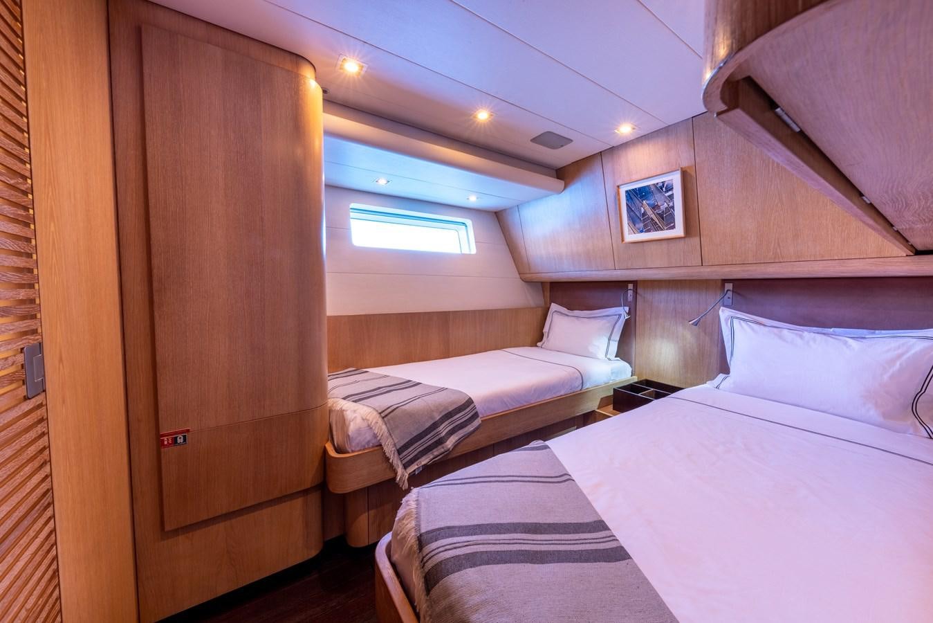 a room with two beds aboard YCH2 Yacht for Sale