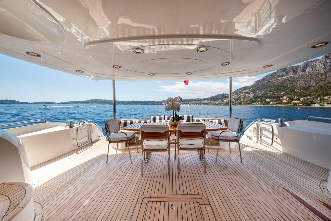 a table and chairs on a deck aboard LADY YOUSRA Yacht for Sale