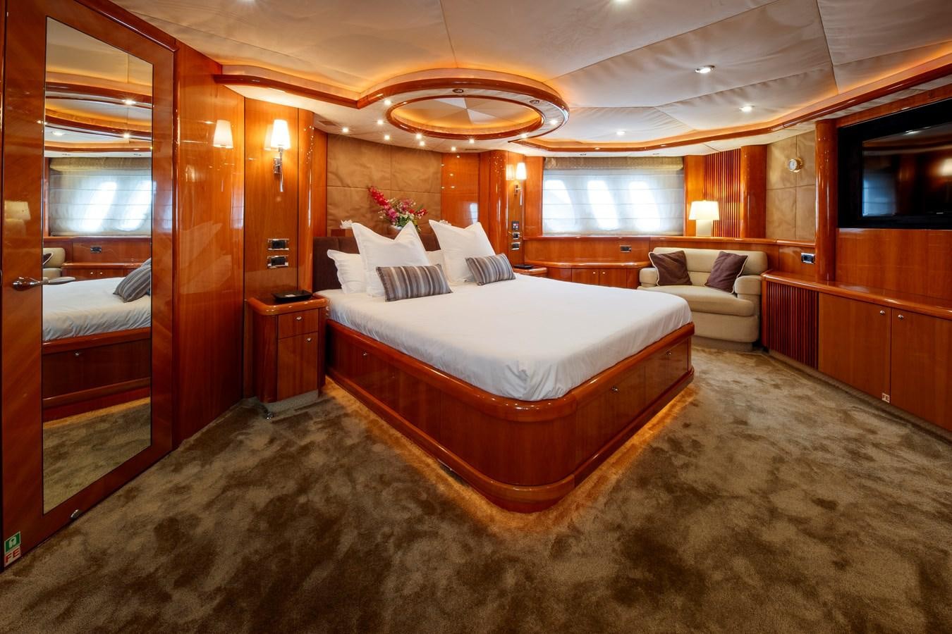a bedroom with a bed and a couch aboard LADY YOUSRA Yacht for Sale