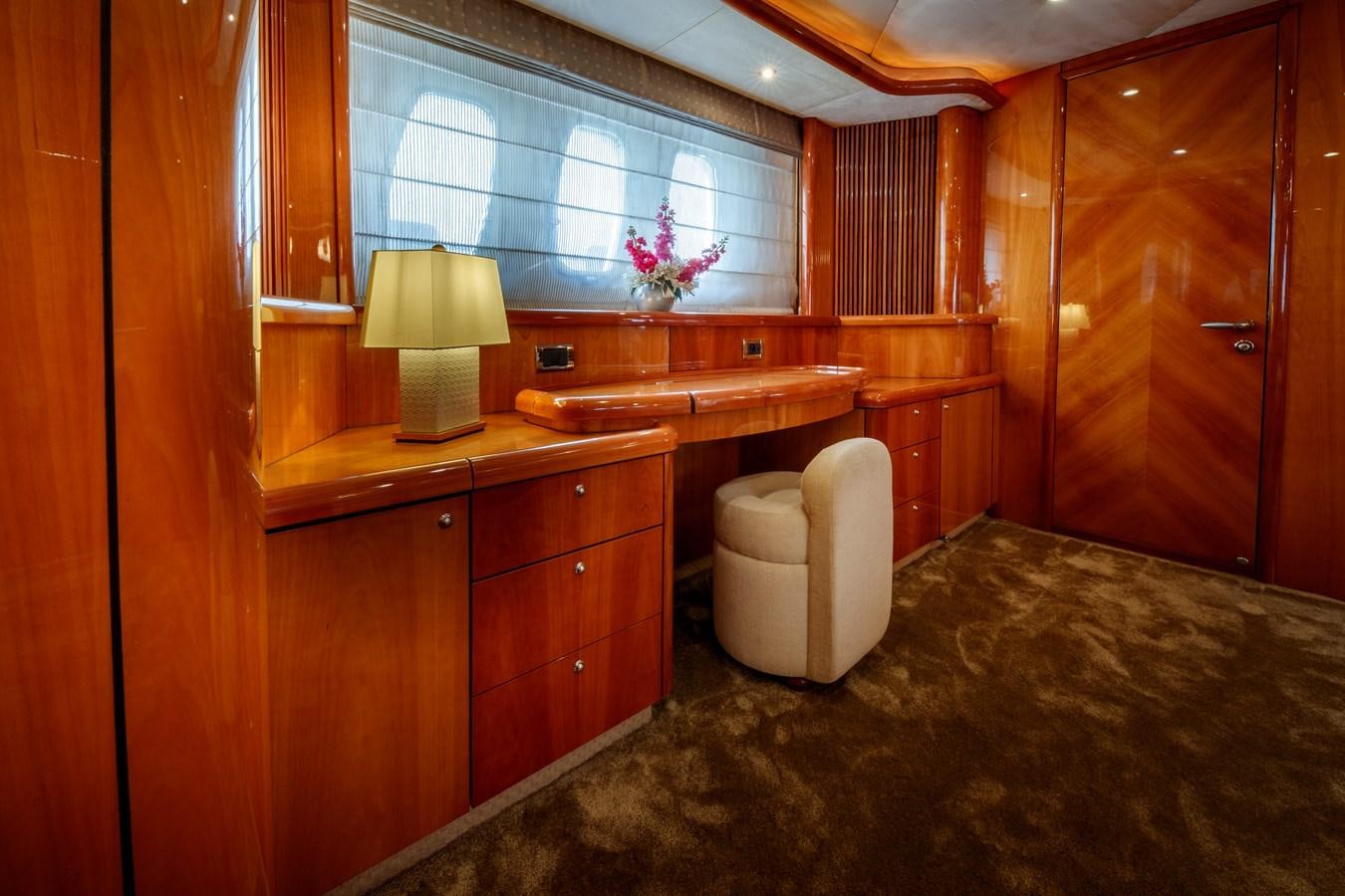 a bathroom with a toilet and a wooden cabinet aboard LADY YOUSRA Yacht for Sale