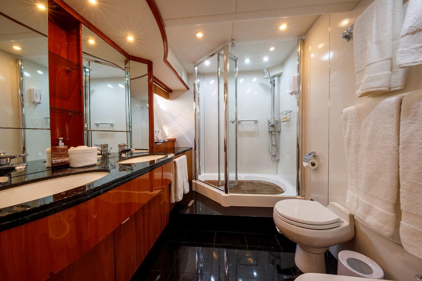 a bathroom with a glass shower aboard LADY YOUSRA Yacht for Sale