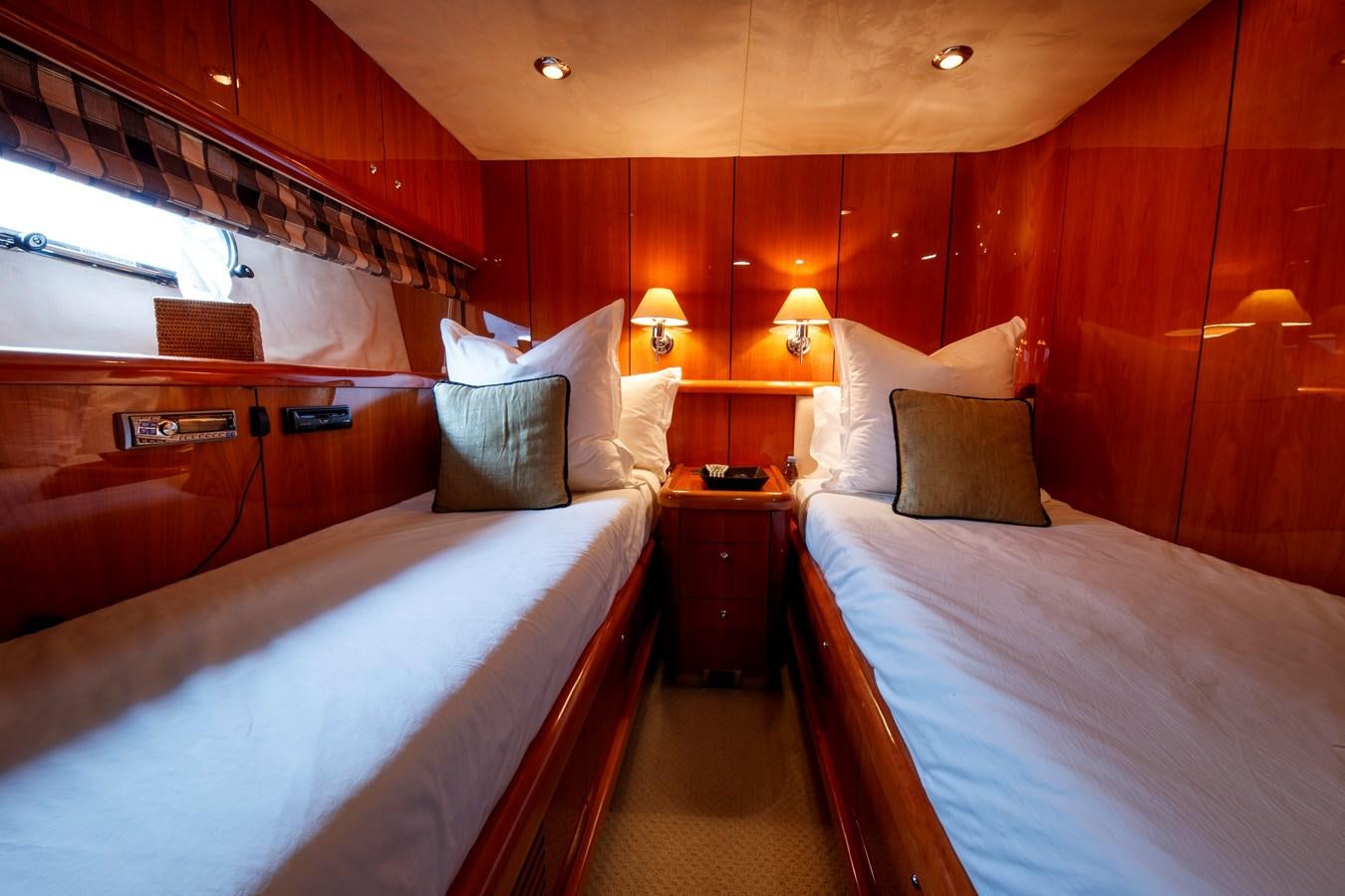 a room with beds and a desk aboard LADY YOUSRA Yacht for Sale