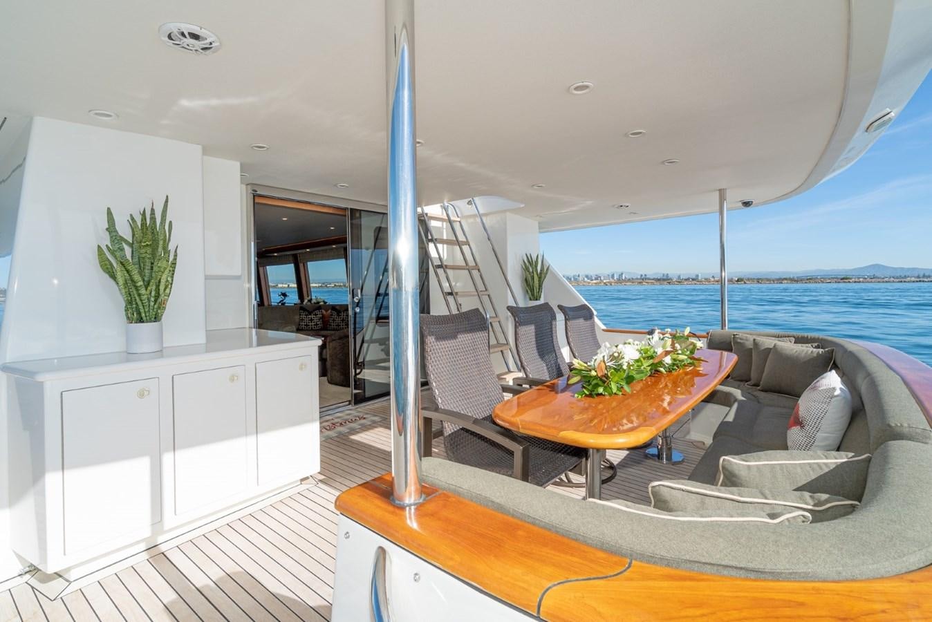 a living room with a large balcony aboard BESAME Yacht for Sale