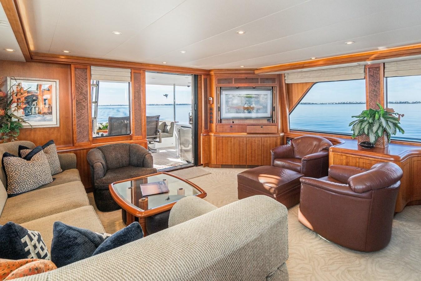 a living room with leather furniture aboard BESAME Yacht for Sale