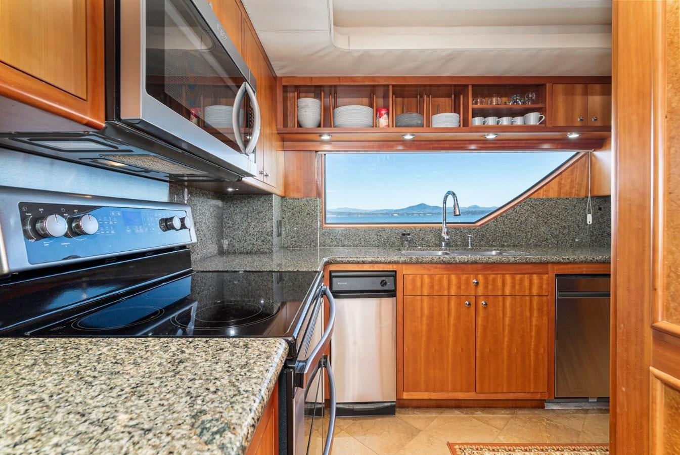 a kitchen with wooden cabinets aboard BESAME Yacht for Sale