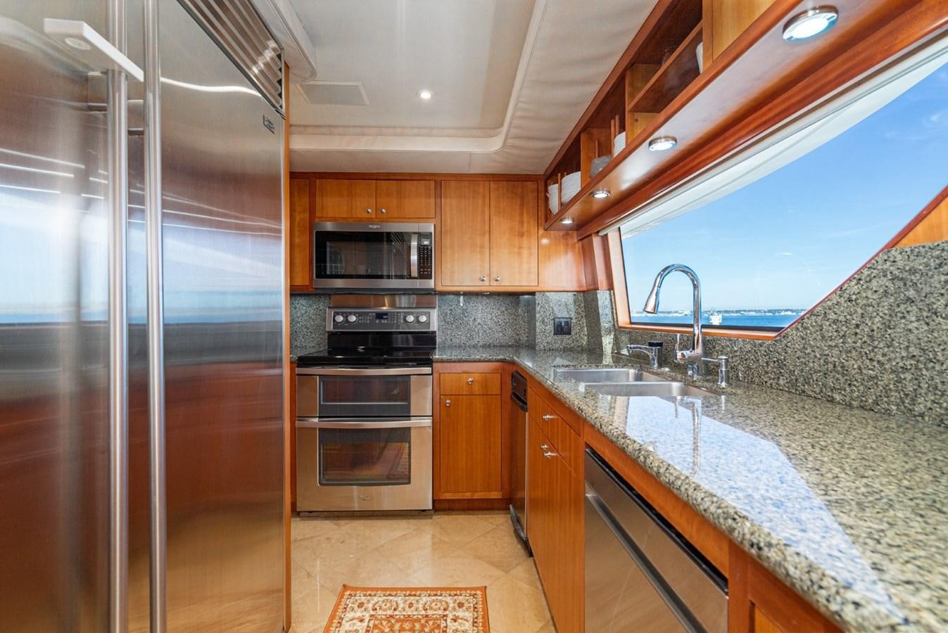 a kitchen with a marble counter top aboard BESAME Yacht for Sale