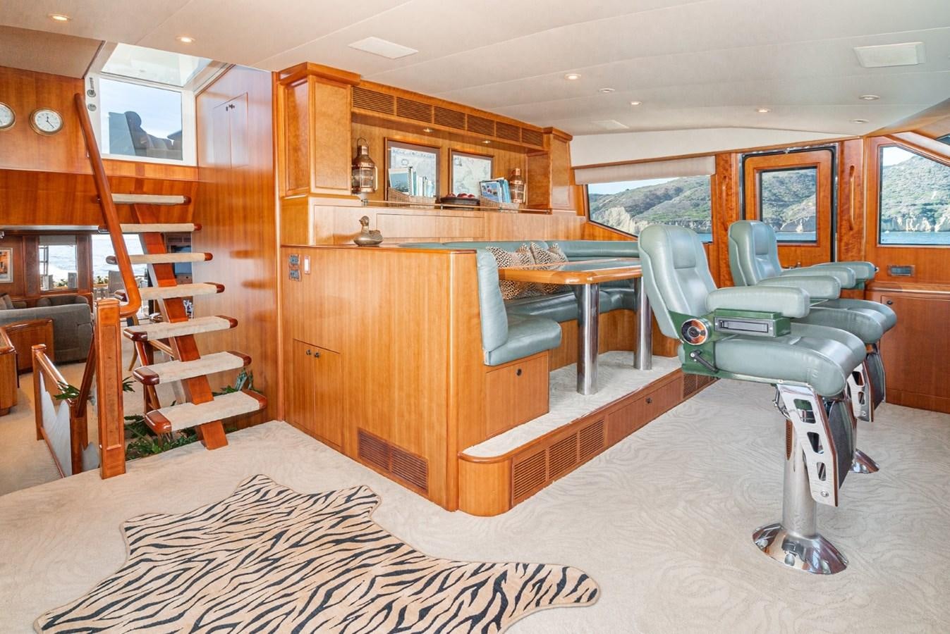 a room with a couch and a table and chairs aboard BESAME Yacht for Sale