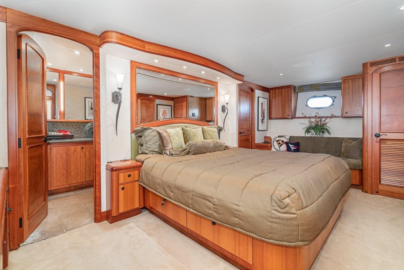 a bedroom with a bed and a closet aboard BESAME Yacht for Sale