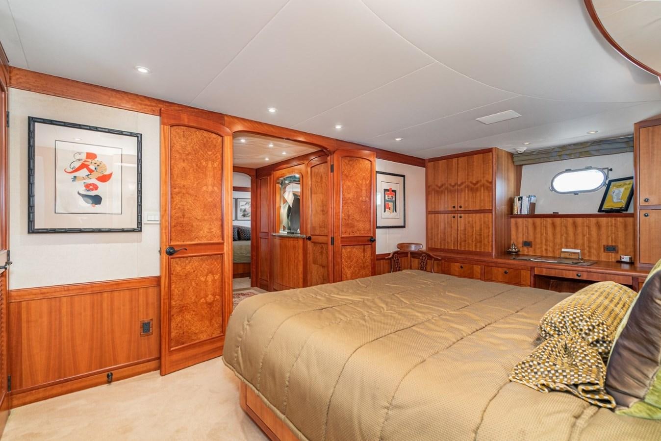 a bedroom with wood cabinets aboard BESAME Yacht for Sale