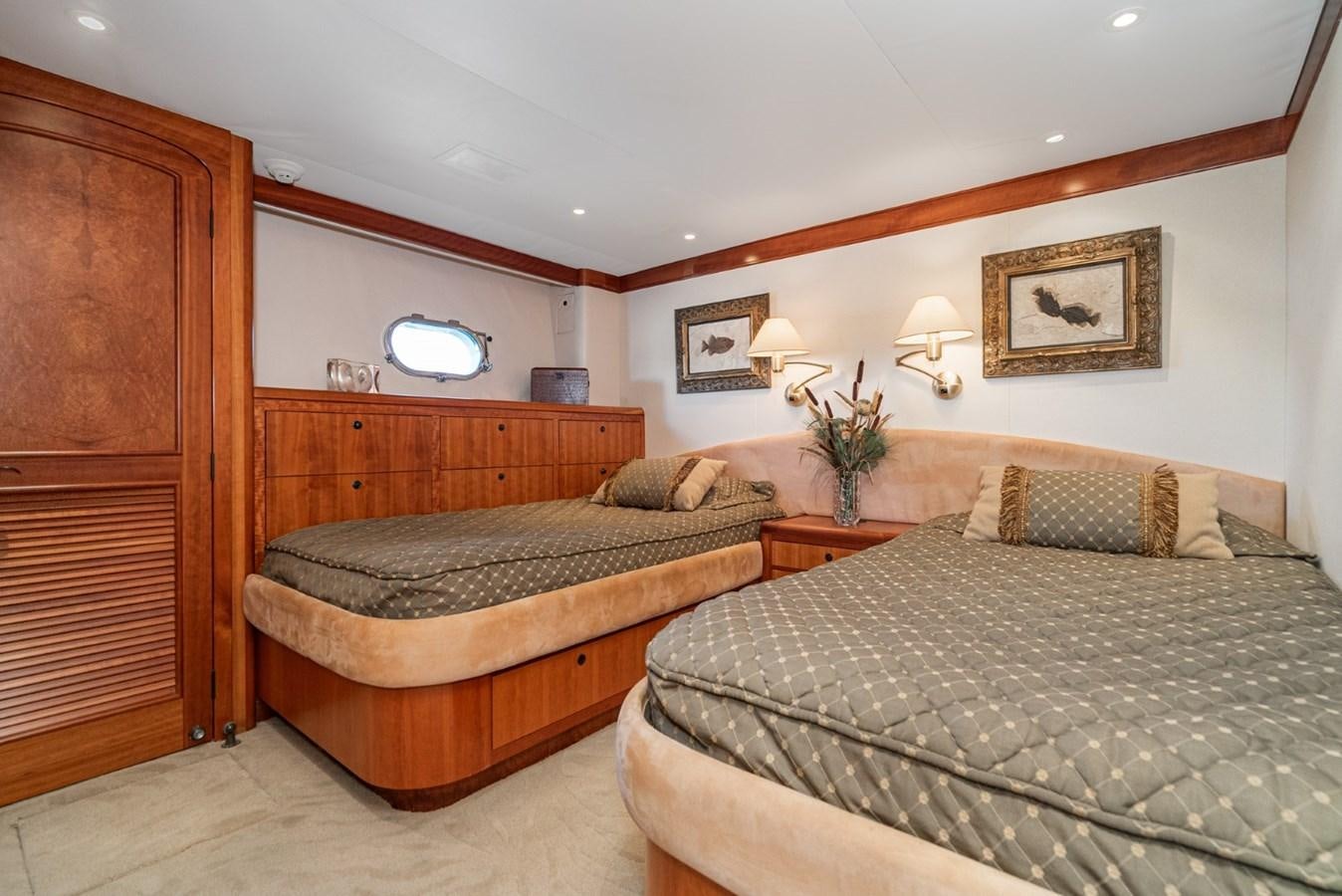 a couple of beds in a hotel room aboard BESAME Yacht for Sale