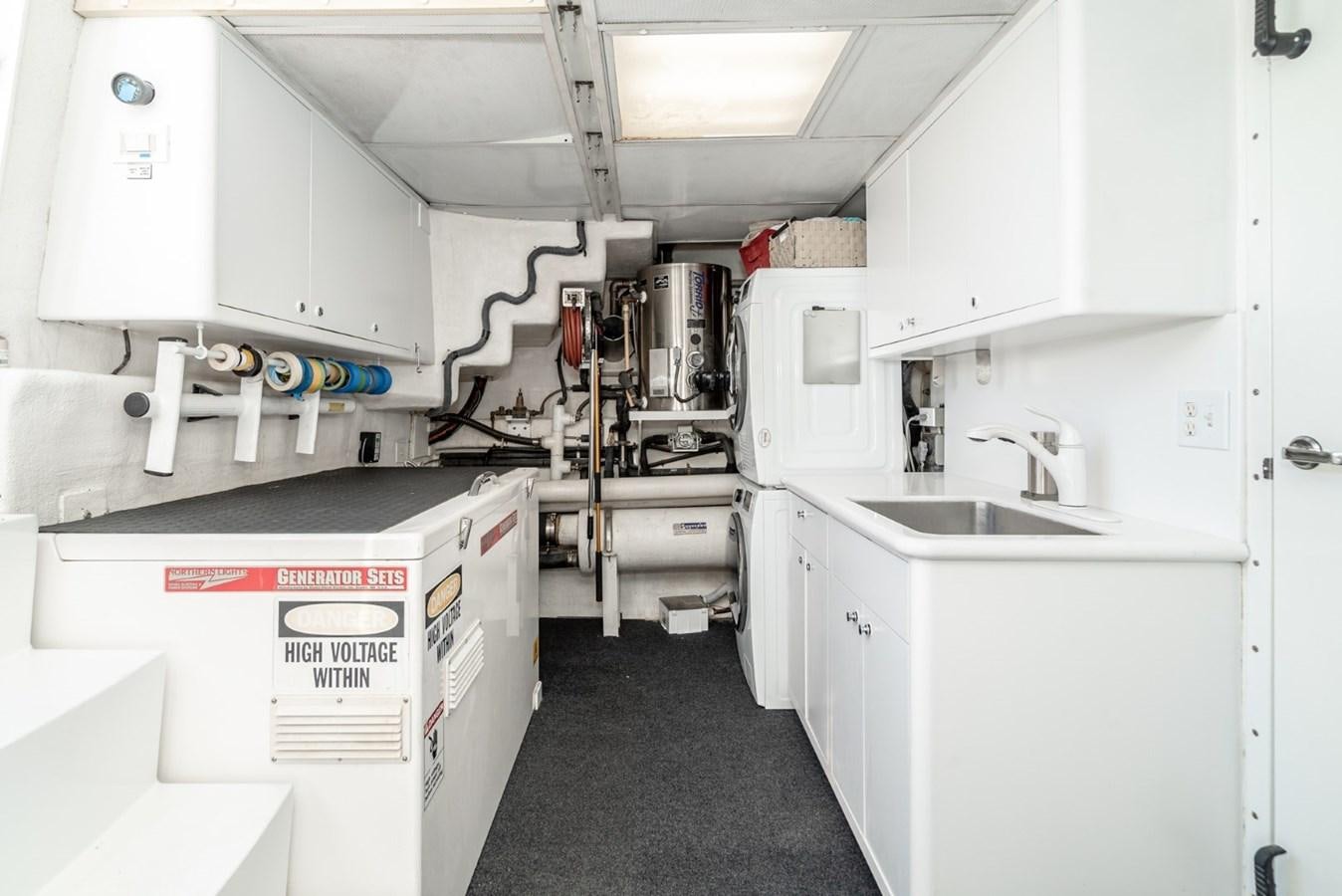 a room with white cabinets and white appliances aboard BESAME Yacht for Sale