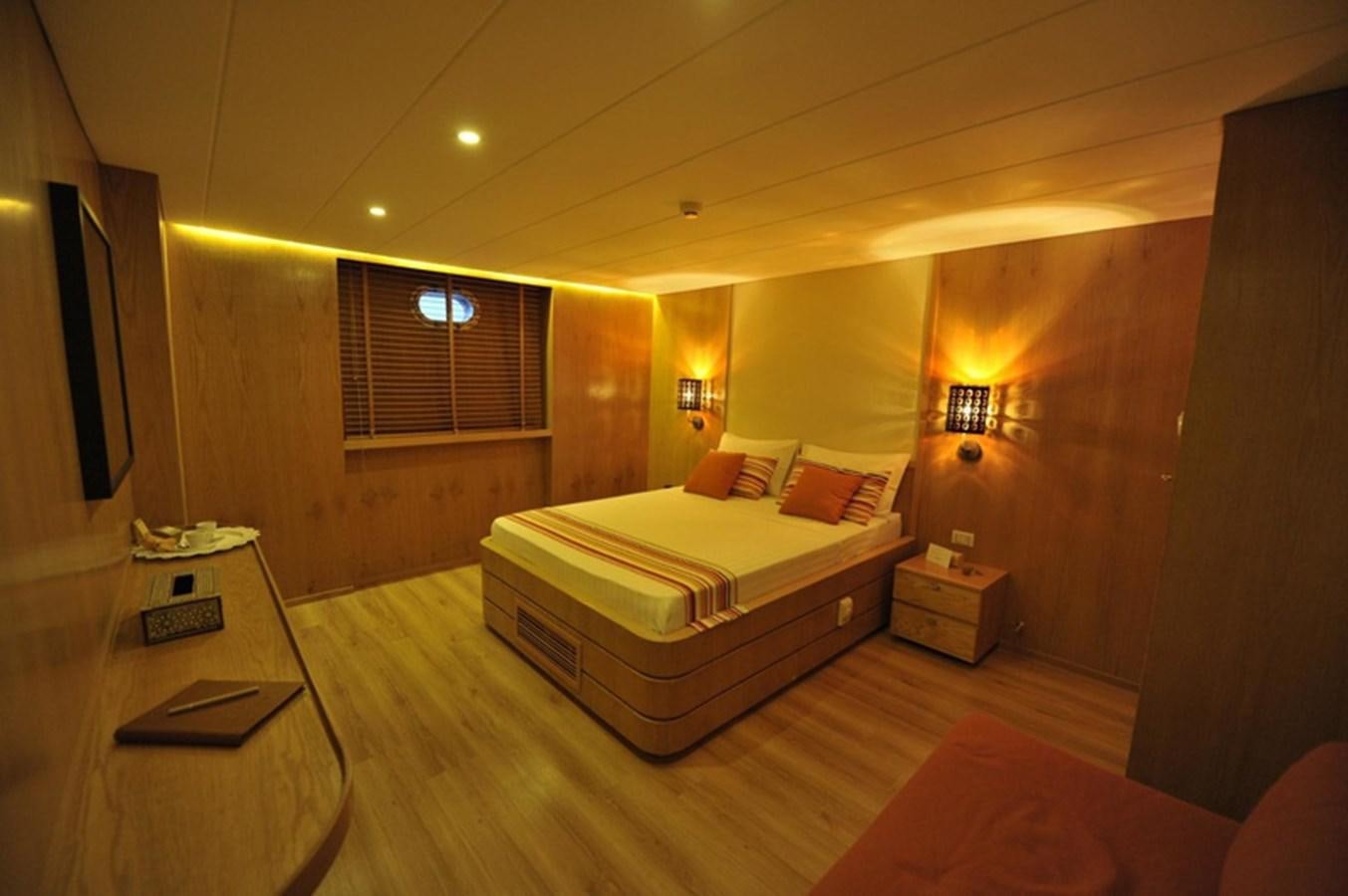 a room with a bed and a tv aboard 2017 SAFARI  142 CUSTOM Yacht for Sale