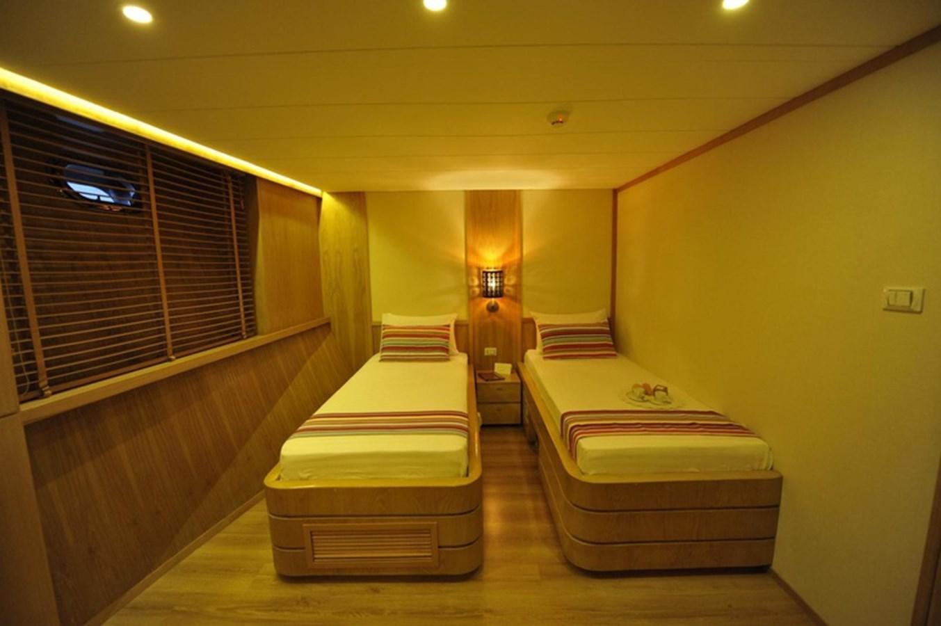 a room with a bed and a lamp aboard 2017 SAFARI  142 CUSTOM Yacht for Sale