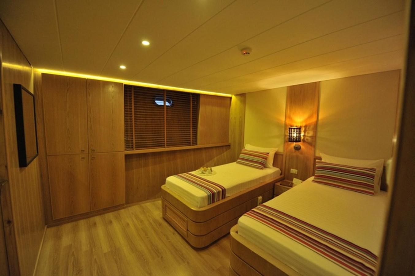 a room with two beds aboard 2017 SAFARI  142 CUSTOM Yacht for Sale