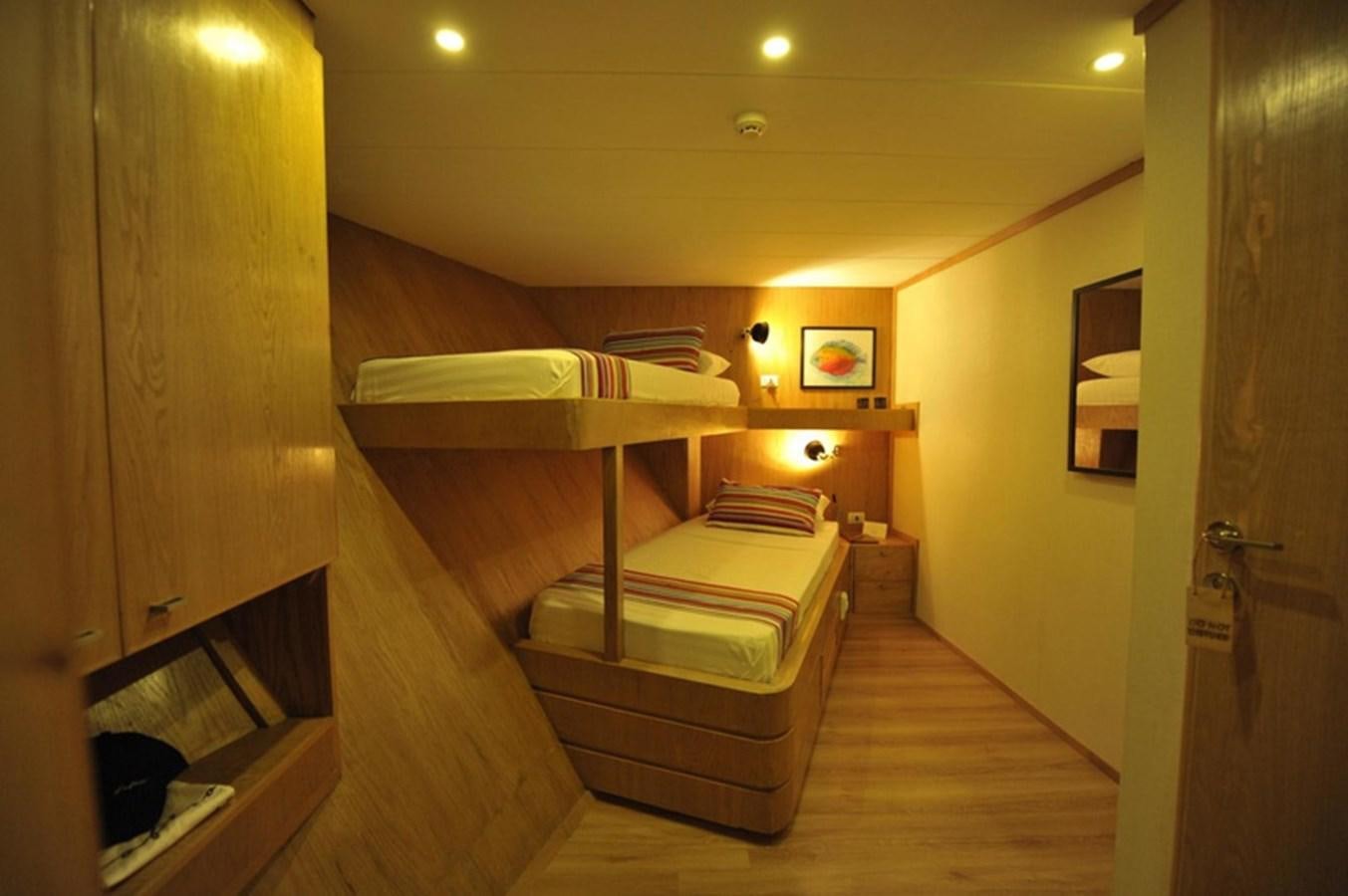 a room with a staircase and a wood floor aboard 2017 SAFARI  142 CUSTOM Yacht for Sale