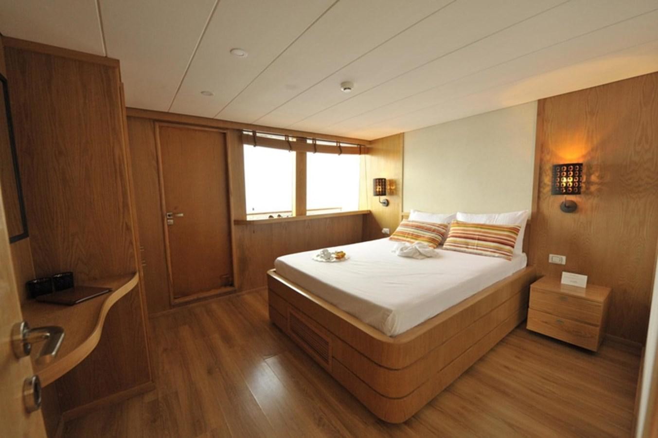 a bedroom with a bed and a closet aboard 2017 SAFARI  142 CUSTOM Yacht for Sale
