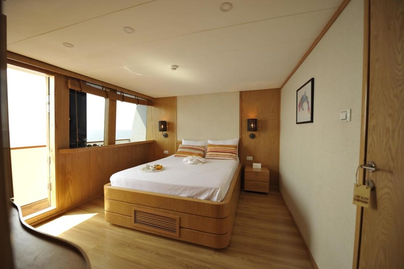 a bedroom with a bed aboard 2017 SAFARI  142 CUSTOM Yacht for Sale