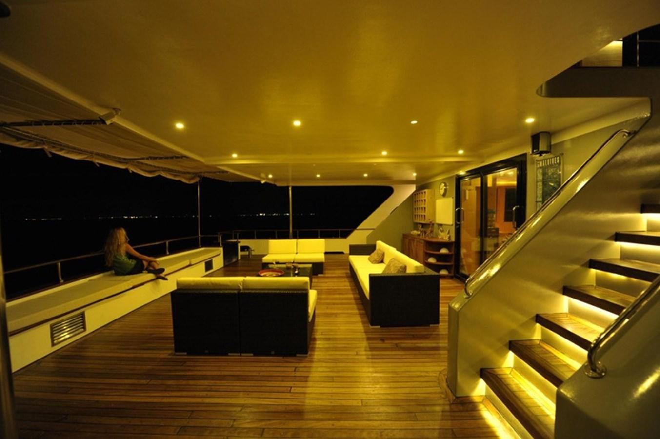 a room with a wood floor and a staircase and a glass wall aboard 2017 SAFARI  142 CUSTOM Yacht for Sale