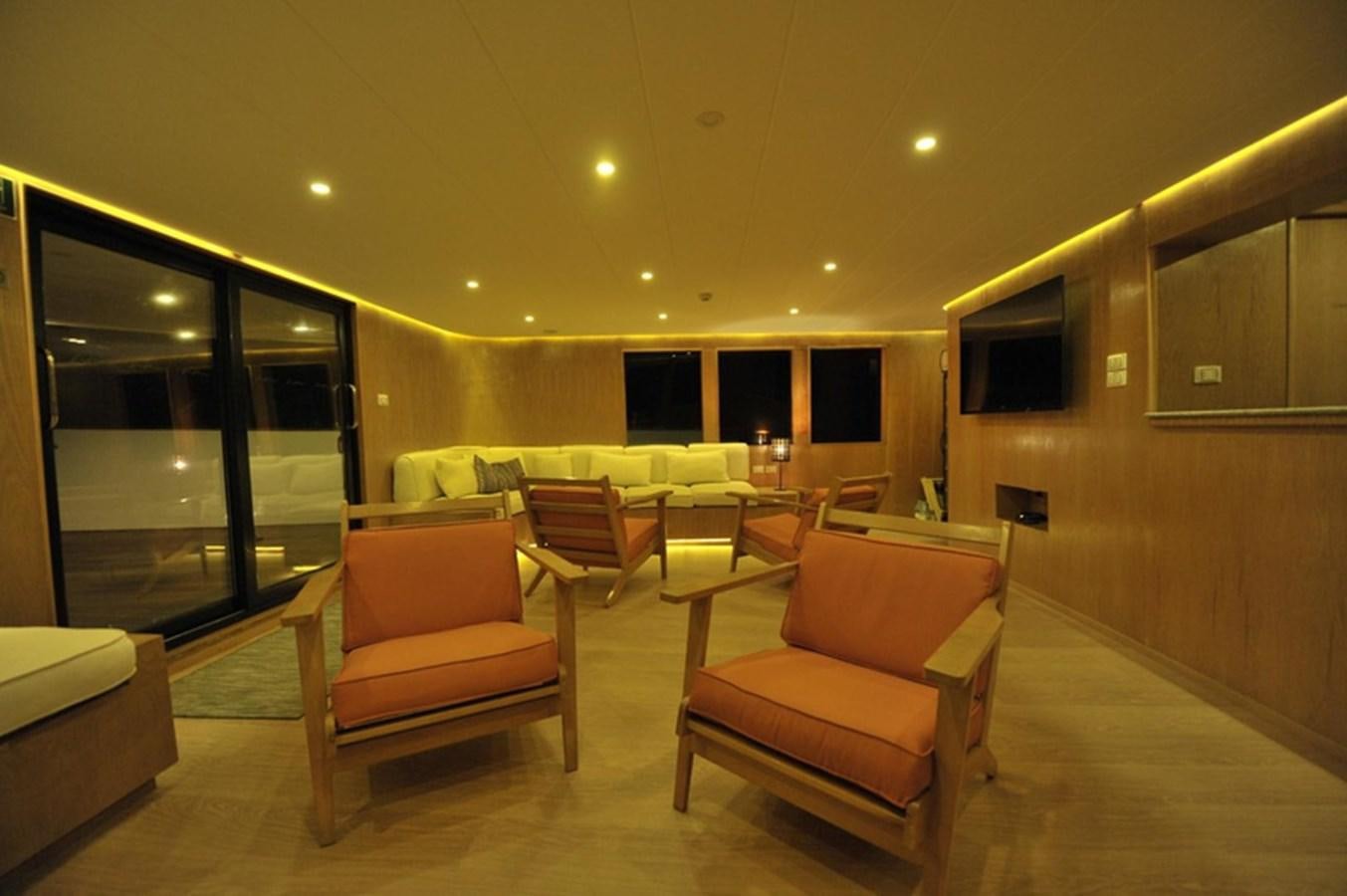a living room with chairs and a couch aboard 2017 SAFARI  142 CUSTOM Yacht for Sale