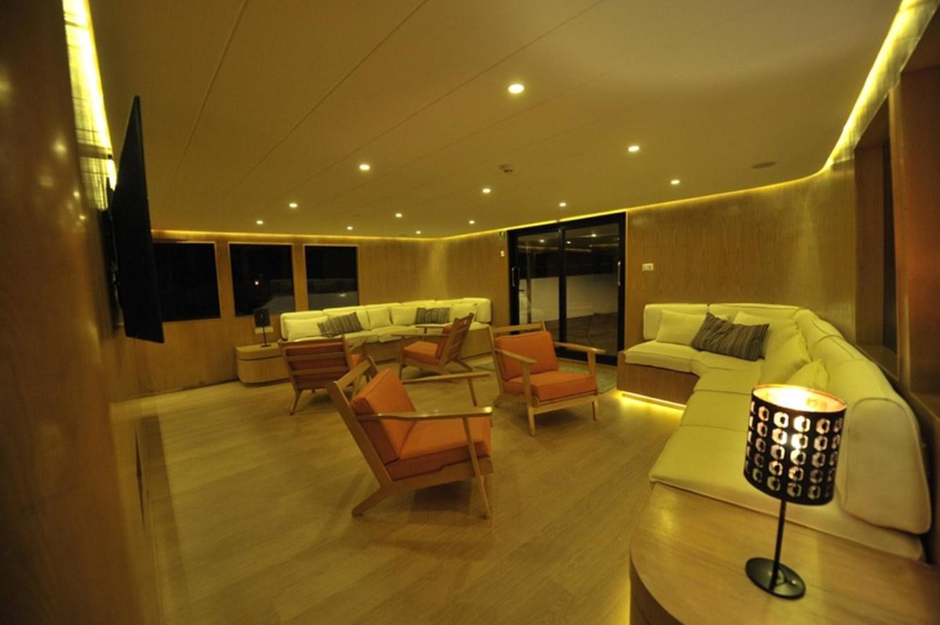a room with a couch and a table aboard 2017 SAFARI  142 CUSTOM Yacht for Sale